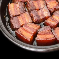 Close-up of succulent pork belly cubes, glistening in a rich sauce, ready for a delicious miso pork belly recipe.
