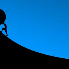 Silhouette d'un homme poussant une énorme sphère sur une pente. L'effort pour un prêt immobilier 30 ans.