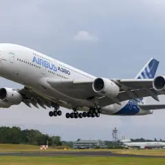 Ogromny Airbus A380 800 z podwoziem w górze startuje z lotniska.