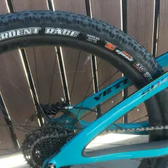 Close-up of a turquoise Yeti mountain bike rear wheel, featuring a Maxxis Ardent Race tire.