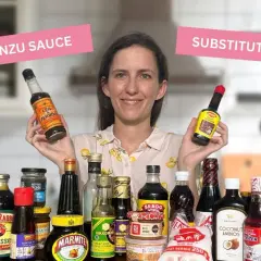 Woman holds Lea & Perrins and Maggi, showcasing various bottles and jars as ponzu sauce substitutes.