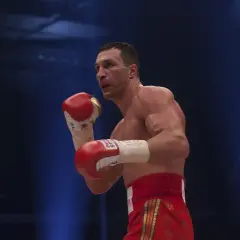 Wladimir Klitschko in a boxing stance, his powerful reach evident as he prepares to strike.