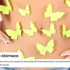 Farfalle nello stomaco, un simbolo di amore o ansia. Mani delicate accarezzano la pancia, circondata da farfalle di carta.