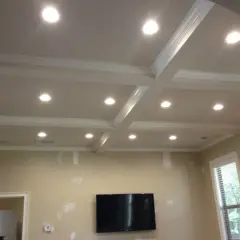 A coffered ceiling with recessed lighting, questioning if recessed lighting is out of style.