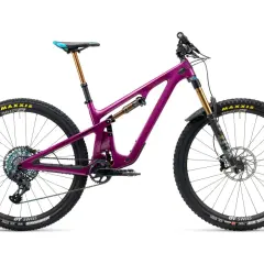 A vibrant purple Yeti SB140 mountain bike, ready for adventure, with gold suspension and colorful drivetrain.