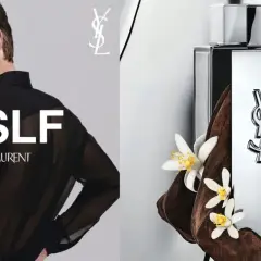 Młody mężczyzna w czarnej, prześwitującej koszuli, obok flakonu perfum Yves Saint Laurent MYSLF, otoczony drewnem i kwiatami.
