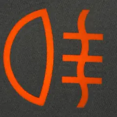 Pomarańczowy symbol świateł do jazdy dziennej na ciemnym tle.