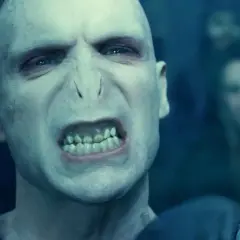 Złowrogi Lord Voldemort, którego grał Ralph Fiennes, z groźnym wyrazem twarzy i zielonymi oczami.