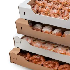 Pączki w pudełkach, gotowe na Tłusty Czwartek. Różne rodzaje słodkości czekają na świętowanie.