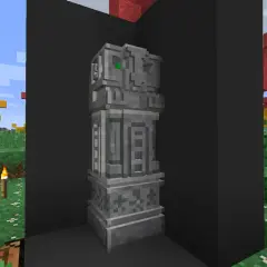 Kamienny monument z zielonymi oczami, jakby wyrzeźbiony dłutem i dłutkami. W tle jesienne drzewa i trawa.