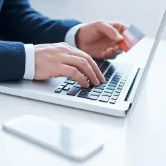 Mężczyzna wpisuje dane karty na laptopie, przygotowując się do aktywacji karty Millenium.