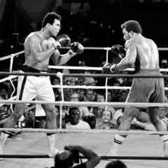 Muhammad Ali in the ring, a pivotal moment in his life events. He faces his opponent, the crowd watching intently.