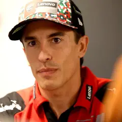 El piloto Marc Márquez, con su físico atlético, luce una gorra del equipo y una polo roja con el logo de Lenovo.