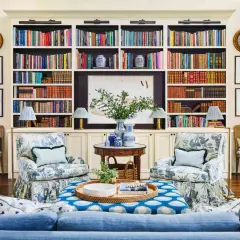 Ideas on how to decorate a bookshelf: a cozy living room with built-in shelves filled with books, art, and decorative vases.