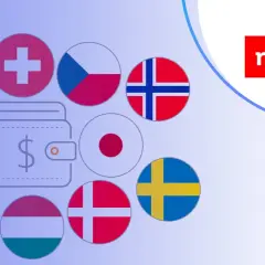 Jak wpłacić euro na konto walutowe mBank? Grafika przedstawia portfel z symbolem dolara otoczony flagami różnych krajów, sugerując międzynarodowe transakcje.