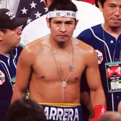 Marco Antonio Boxer, the champion, stands ready, a championship belt held high by his team.