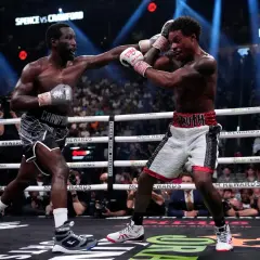 Two boxers exchange punches in a tense moment, with the crowd watching intently. The scoreboard shows "ROUND 5," highlighting the ongoing battle for boxing scoring punches.