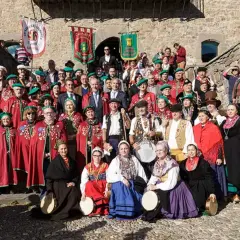Grupo posa con trajes tradicionales en la fiesta del orujo Potes, algunos portan tambores y panderetas.