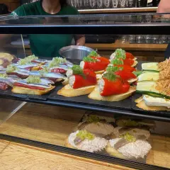 Leckere Tapas in Barcelona: Sardinen auf Brot, gefüllte Paprika und Zucchini-Käse-Häppchen. Perfekt für deine kulinarischen Barcelona Tipps!