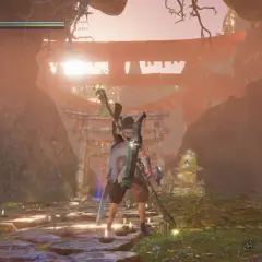 Postać w grze Nioh 2 stoi przed bramą torii w mistycznej scenerii.