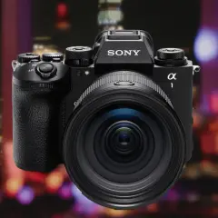 Profesjonalny aparat Sony A1 II z obiektywem na tle nocnego miasta.