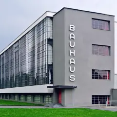 Iconic Bauhaus architecture examples: the Dessau building with its glass curtain wall and prominent "BAUHAUS" lettering.