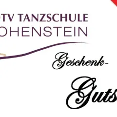 Tanzschule Hohenstein: Ein Geschenkgutschein, verpackt mit einer roten Schleife, wartet darauf, Freude zu schenken.