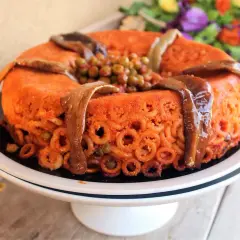 Timballo di anelletti alla palermitana ricetta originale: un capolavoro di pasta, melanzane e piselli, pronto per essere gustato.