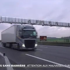 Camion passant sous un portique de péage sans barrière. Le paiement du péage flux libre est automatique.