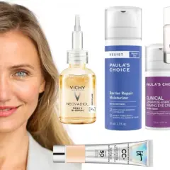 En kvinna med blont hår och blå ögon omgiven av hudvårdsprodukter, inklusive Vichy Neovadiol Meno 5 Bi-Serum, perfekt för hudvård under klimakteriet.