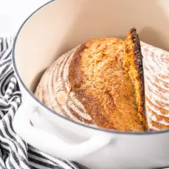 Pyszny, świeżo upieczony chleb z garnka, z chrupiącą skórką i puszystym wnętrzem, czeka na krojenie.