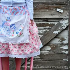A vintage apron skirt pattern with a girl watering flowers, set against a rustic wooden background.