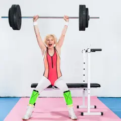 Madeleine Vall Beijner lyfter skivstång över huvudet, glad och stark i gymkläder.
