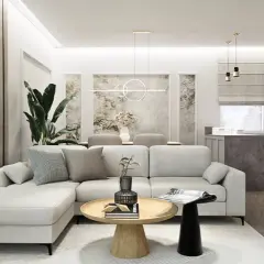 Nowoczesny salon z aneksem kuchennym, jasna sofa, drewniany stolik kawowy, dekoracje ścienne.