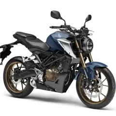 Niebieski motocykl Honda CB125R, jeden z najszybszych 125, z brązowymi felgami i okrągłym reflektorem.