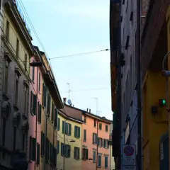 Edifici colorati di Bologna, con un semaforo verde che promette una vivace vita notturna.