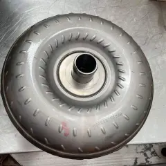 Metalowy element, jeden z rodzajów sprzęgieł, z widocznym numerem seryjnym.