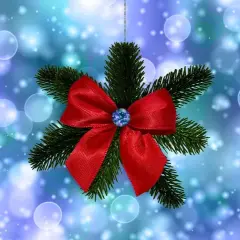 Un lazo de navidad rojo brillante adorna una rama de pino, suspendido sobre un fondo azul con luces bokeh.