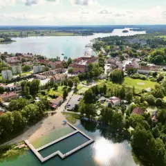 Malownicze miasteczko nad jeziorem, z plażą i basenem kąpielowym. Ryn oferuje piękne widoki i relaks.