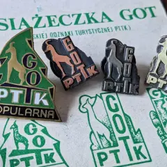 Książeczka GOT z odznakami turystycznymi PTTK. Widoczne cztery odznaki z kozicą i napisem GOT PTTK w różnych kolorach.