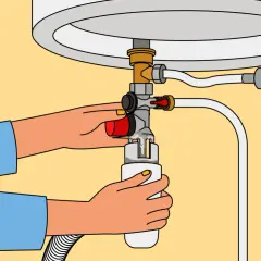 Illustration du fonctionnement du groupe de sécurité d'un chauffe-eau : une main actionne la purge.