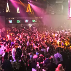Folla in delirio all'Alcatraz Club Milano, luci rosa e arancioni illuminano la pista da ballo gremita di giovani.