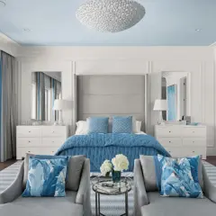 Serene master bedroom layout ideas with a blue and white palette, featuring a plush bed, mirrored nightstands, and comfortable seating.