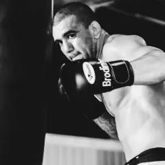 Boxer throws a powerful punch, demonstrating what is a check hook.