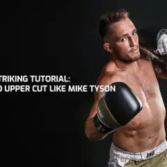 MMA fighter demonstrates a powerful uppercut to the body, channeling the legendary Mike Tyson.