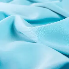 Soft, flowing turquoise lyocell fabric with subtle texture.