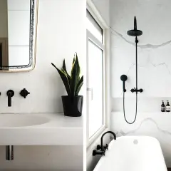 Modernt badrum med svart kran och dusch, perfekt för att renovera badrum. Marmorväggar och en stilren kommod.