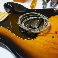 Nowe struny czekają na założenie na gitarę. Zobacz, jak łatwo to zrobić!