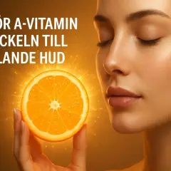 En kvinna med slutna ögon håller upp en apelsinskiva som lyser. Texten "Varför A-vitamin är nyckeln till strålande hud" antyder att vitaminet ger en frisk och glödande hud.