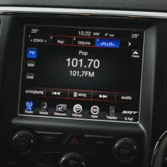 Ekran radia w samochodzie pokazuje stację 101,7 FM. Widać opcje strojenia, co może być przydatne przy przestrajenie radia z USA na Europę.